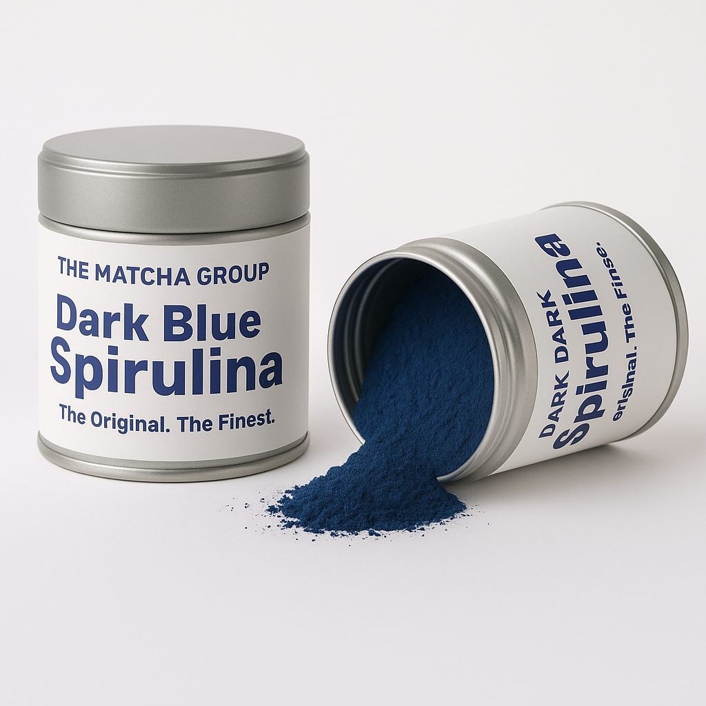Two tins of Dark Blue Spirulina powder with visible spirulina powder spilling out on a white background.

